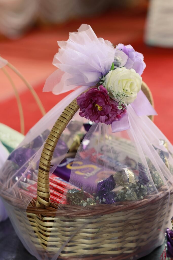 Beautiful wicker basket adorned with flowers and filled with gifts, perfect for celebrations.